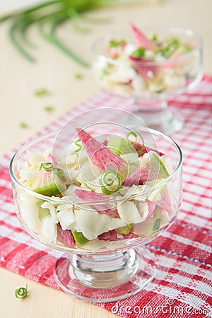 Two glasses of pink radish salad with cabbage Stock Photo