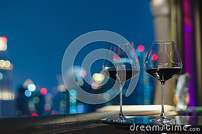 Two glasses of red wine on table of rooftop bar Stock Photo