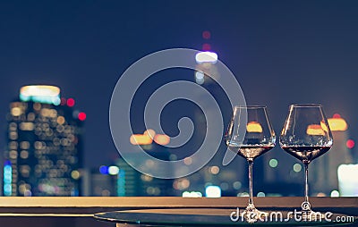 Two glasses of red wine on table of rooftop bar Stock Photo
