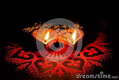 Two glowing terracotta lamps against dark background in Diwali concept Stock Photo