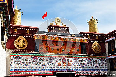 Two golden deer flanking a Dharma wheel on Jokhang Editorial Stock Photo