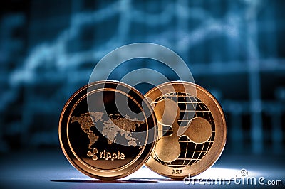 Two golden xrp ripple coins with financial charts on background Editorial Stock Photo