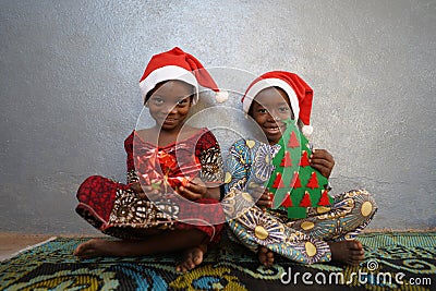 Two Gorgeous African Black Children Present and Christmas Tree Stock Photo