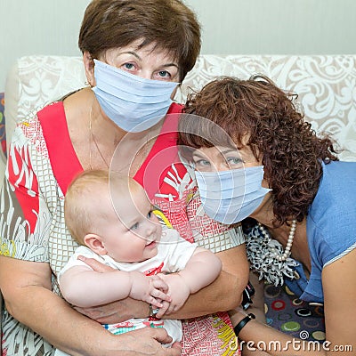 Two grandmothers play with a little granddaughter Stock Photo