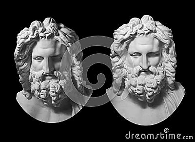 Two gypsum copy of antique statue Zeus head isolated on black background. Plaster sculpture man face with beard. Stock Photo
