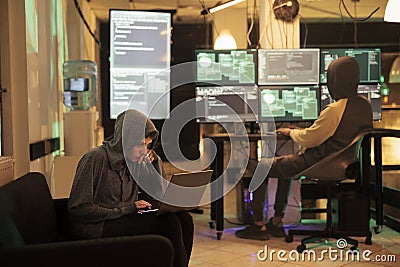 Two hackers working on computers to crack encryption Stock Photo