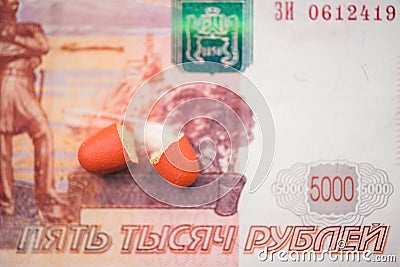 The two halves of the red pill lie on the banknote of five thousand russian rubles. Stock Photo