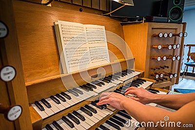 Two hand playing a church organ in Kristkirken Editorial Stock Photo