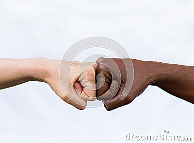 Two hands of different racial colors, punching each other, expressing victory, agreement. The concept of ending racism Stock Photo