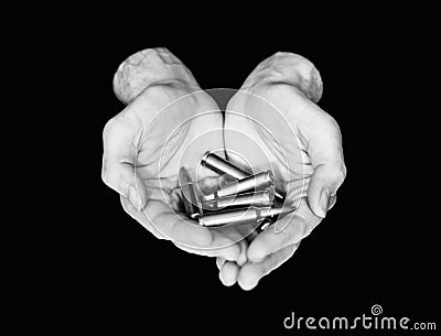 Two hands holding bullets isolated on black Stock Photo