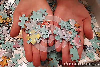 Two hands pick up puzzles Stock Photo