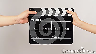 Two hands send and hold Black clapper board or movie slate on white background Stock Photo