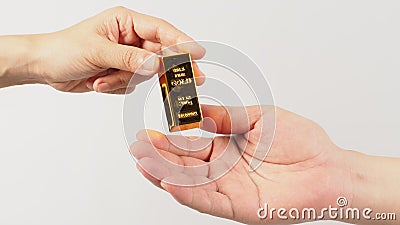 Two hands send and recive gold bar on white background Stock Photo