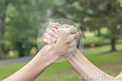 Two hands of teenagers are fighting among themselves in the park and the forest Stock Photo