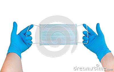 Two hands wearing blue gloves holding facial medical mask prepare to ware for protect allergic reaction or infectious diseases Stock Photo