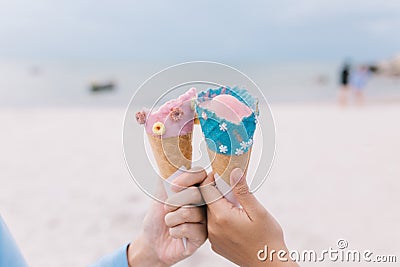 Two hands young teen women holding ice cream cone on summer in beach and sea. Stock Photo