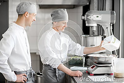Confectioners working at the bakery manufacturing Stock Photo