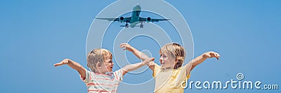 Two happy boys on the beach and a landing plane. Traveling with children concept BANNER, long format Stock Photo