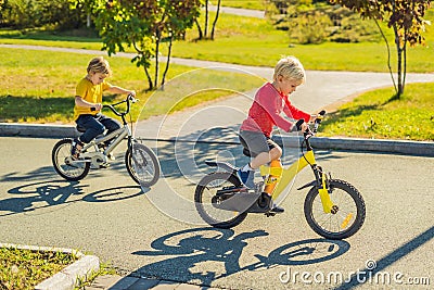 Two happy boys cycling in the park Stock Photo