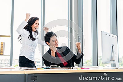 Two happy business people celebrate at office Stock Photo