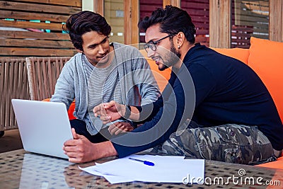 Two happy businessmen discussing freelancer strategy in a meeting, Indian business man remote work freelancing sitting Stock Photo