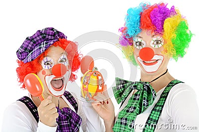 Two happy cheerful clowns make music with toy instruments Stock Photo