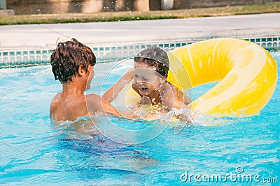 Two happy child having fun on summer pool. Boys playing at outdoor swimming pool Stock Photo