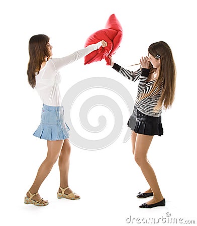 Two happy girlfriends fighting a pillows Stock Photo