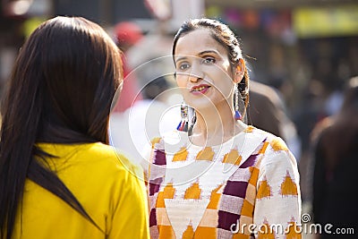 Two women having fun at Surajkund Mela Stock Photo