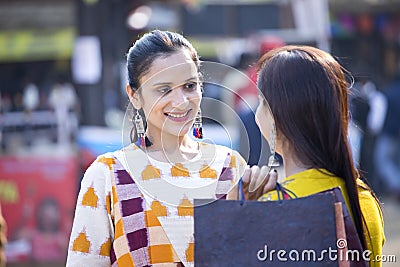 Two women having fun at Surajkund Mela Stock Photo