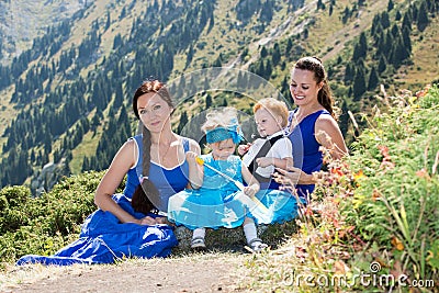 Two happy moms and children girl and boy hugging on nature Stock Photo