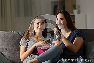 Happy roommates wathing tv in the night Stock Photo