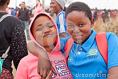 two happy smiling african beautiful young girls embrace outdoors on people celebrating Umhlanga rite background close up Editorial Stock Photo