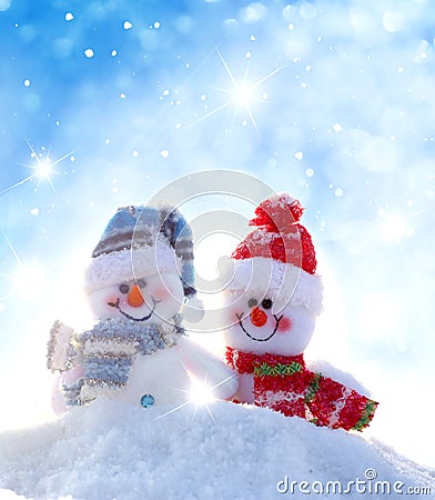 Two happy snowmen standing in winter landscape Stock Photo