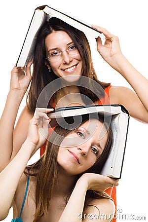 Two happy women friends with books play and smile Stock Photo