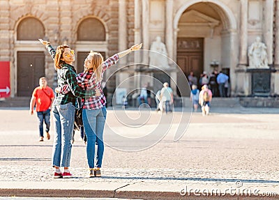 Happy Women friends hugging and admiring view of Semper Opera Theatre in Dresden Stock Photo