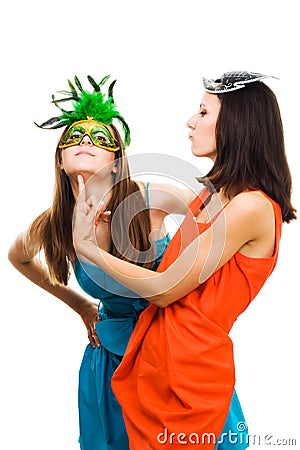 Two happy women play in venetian maquarade masks Stock Photo