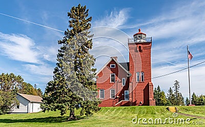 Two Harbors Lighthouse on a Knoll of Grassy Lawn Stock Photo