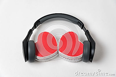 Two heart shape boxes and earphones on white background. Music with love Stock Photo