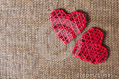 Two Hearts on burlap Background. Wedding Love Concept Stock Photo