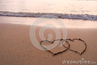 Two hearts drawn in beach Stock Photo