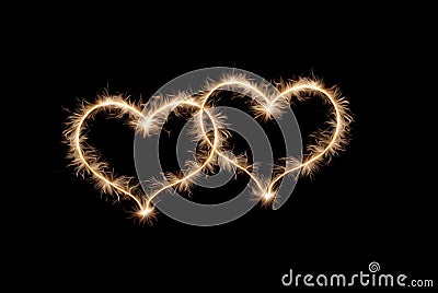 Two hearts drawn by sparklers . Stock Photo