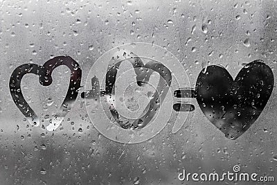 Two hearts with plus sing and equality sign on window in Rainy weather , valentine`s day Stock Photo