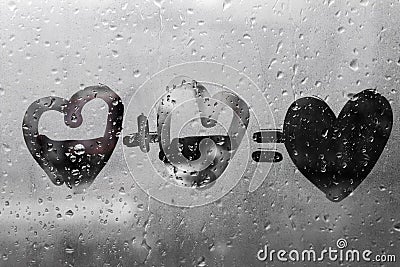 Two hearts with plus sing and equality sign on window in Rainy weather , valentine`s day Stock Photo