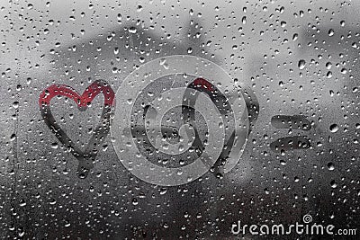 Two hearts with plus sing and equality sign on window in Rainy weather Stock Photo