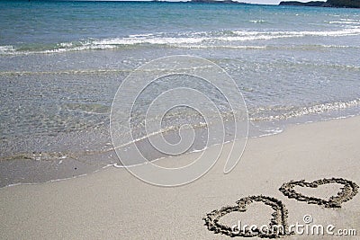 Two hearts written on sand Stock Photo