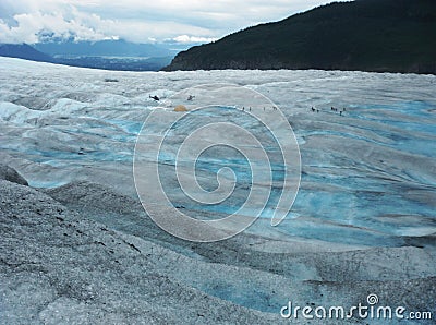 Two Helicopters, Tent And A Dozen Of Hikers On Mendenhall Glacier, Alaska Stock Photo