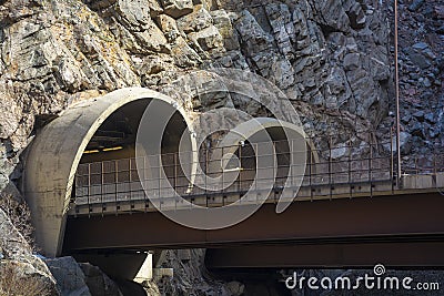 Two Highway Tunnel Entrances cut into a Mountainside Stock Photo