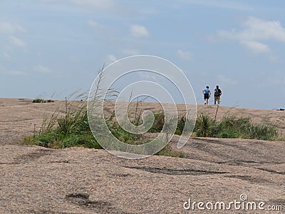 Hikers atop Enchanted Rock, Texas Editorial Stock Photo