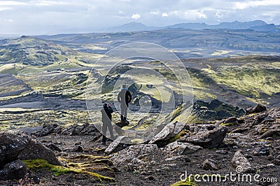 Two hikers looking at volcanic landscape in Lakagigar, Laki craters, Iceland Editorial Stock Photo